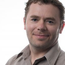 Head shot of Brad Needham against a white background.